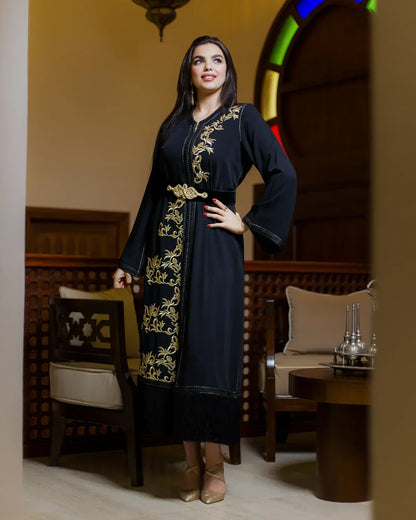 Full-length view of the modern black caftan LAHN featuring bottom fringe detail