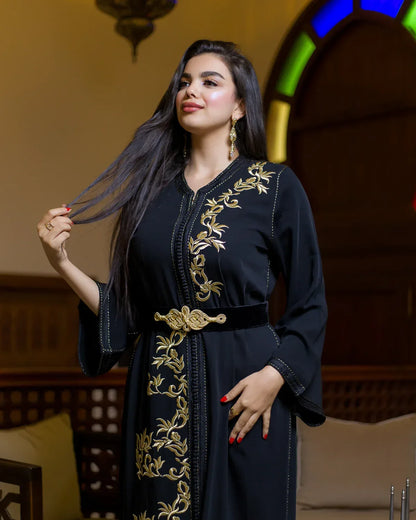 Model wearing the LAHN black Moroccan caftan with gold detailing upper body view