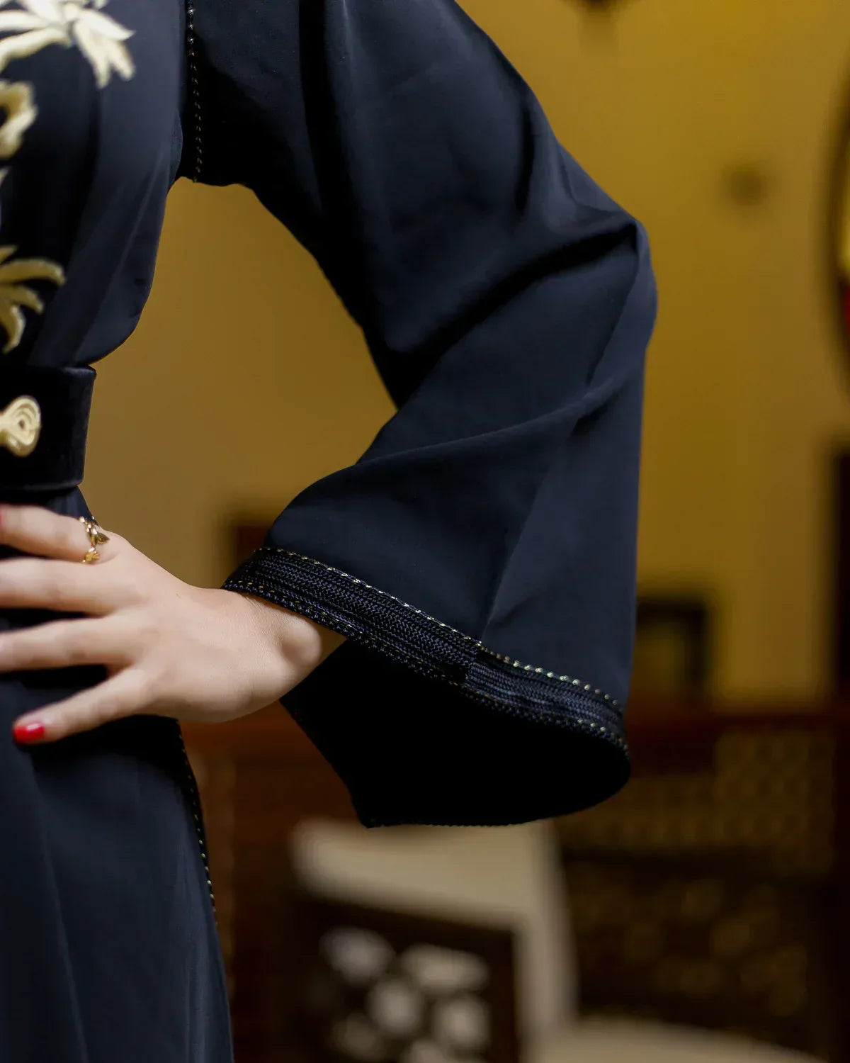 Close-up of the wide sleeve and dark stitch trim on the LAHN black Moroccan caftan