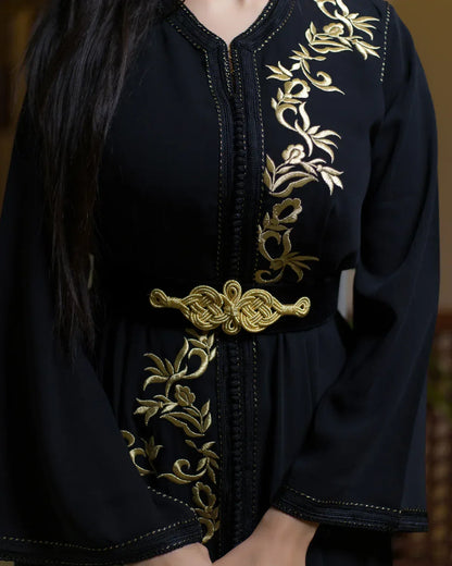Close-up of the elegant golden knot belt and torso embroidery on black caftan