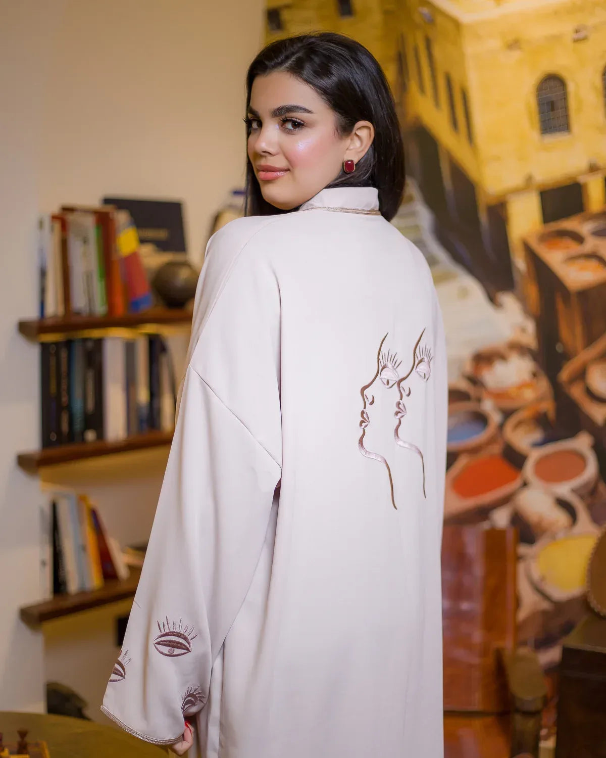 Detailed shot of the eye motif Rabati embroidery on the sleeves of the WATAR beige kimono.